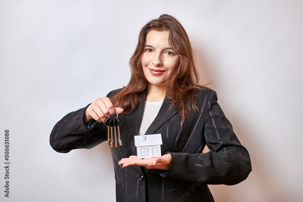 Pretty girl holding house layout and keys. Construction, real estate, mortgage. Pretty girl holding house layout and keys. Construction, real estate, mortgage.