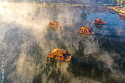 Aerial view of Sunrise with fog over Ban Rak thai, chinese village near a lake in Mae Hong Son, Thailand