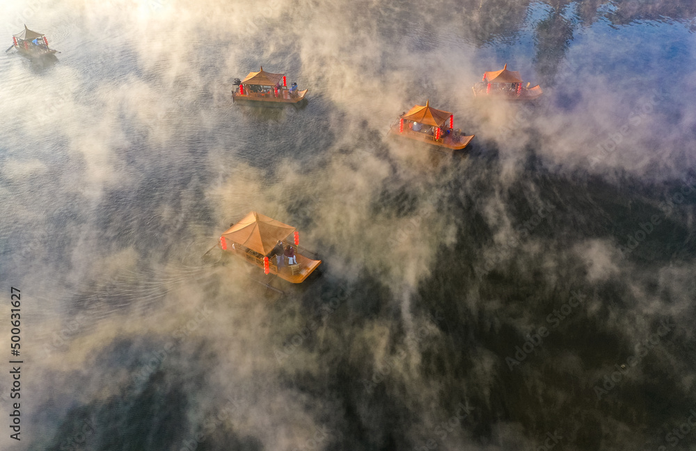 Fototapeta premium Aerial view of Sunrise with fog over Ban Rak thai, chinese village near a lake in Mae Hong Son, Thailand