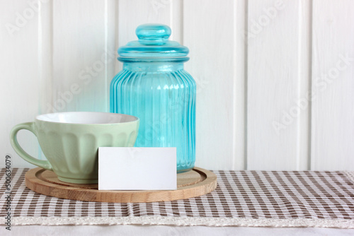 mockup with an empty business card on the table with dishes