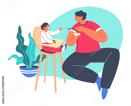 Dad feeding small boy sitting in chair, parenthood
