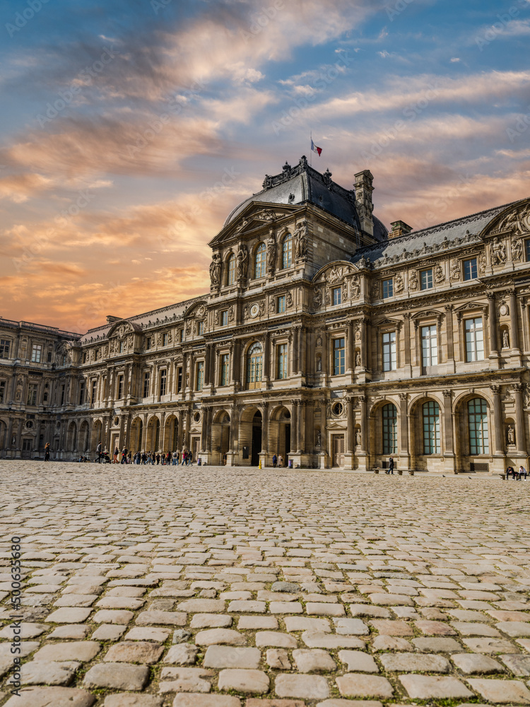 Pavillon Richelieu of the Louvre Palace with dramatic sky in Paris