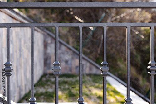 Modern metal railings and handrails in the loft style. The metal is treated with a primer and anti-corrosion paint. Interior design in industrial style.
