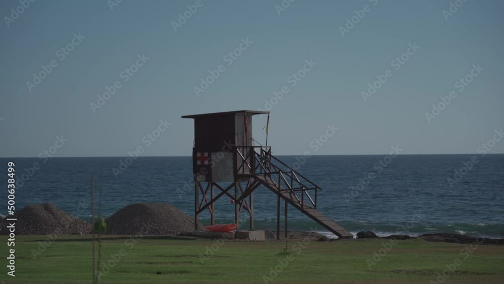 A wooden lifeguard tower by the raging Mediterranean Sea in Cyprus, Paphos. A timber rescue platform by the stormy Mediterranean Sea in the city of Pafos. Swimming safety in the sea A wooden lifeguard tower by the raging Mediterranean Sea in Cyprus, Paphos. A timber rescue platform by the stormy Mediterranean Sea in the city of Pafos. Swimming safety in the sea
