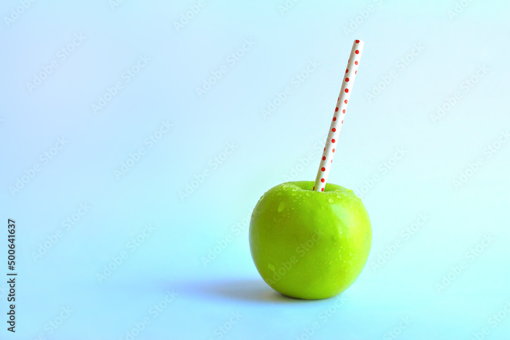 Apple with straw for juice natural fruit drink creative minimal concept. Apple with straw for juice natural fruit drink creative minimal concept.