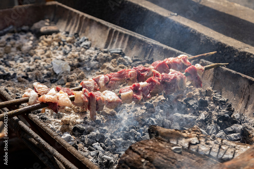 Skewers of traditional Espetada, cooking in a barbecue, Faial, Madeira, Portugal 