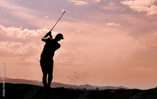 silhouette of a golfer in mid swing