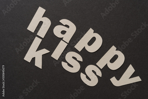 letter cut outs on paper - reads: "happy kiss"