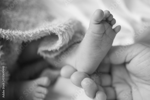 baby feet and mothers hand