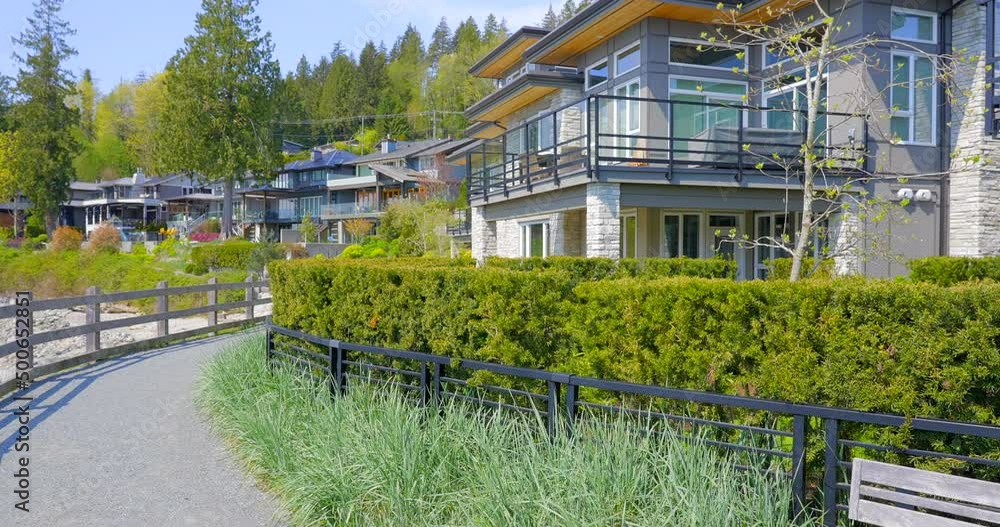 Establishing shot of modern apartment building with beautiful spring blossom landscape in Vancouver, Canada, North America. Day time on April 2022. ProRes 422 HQ.