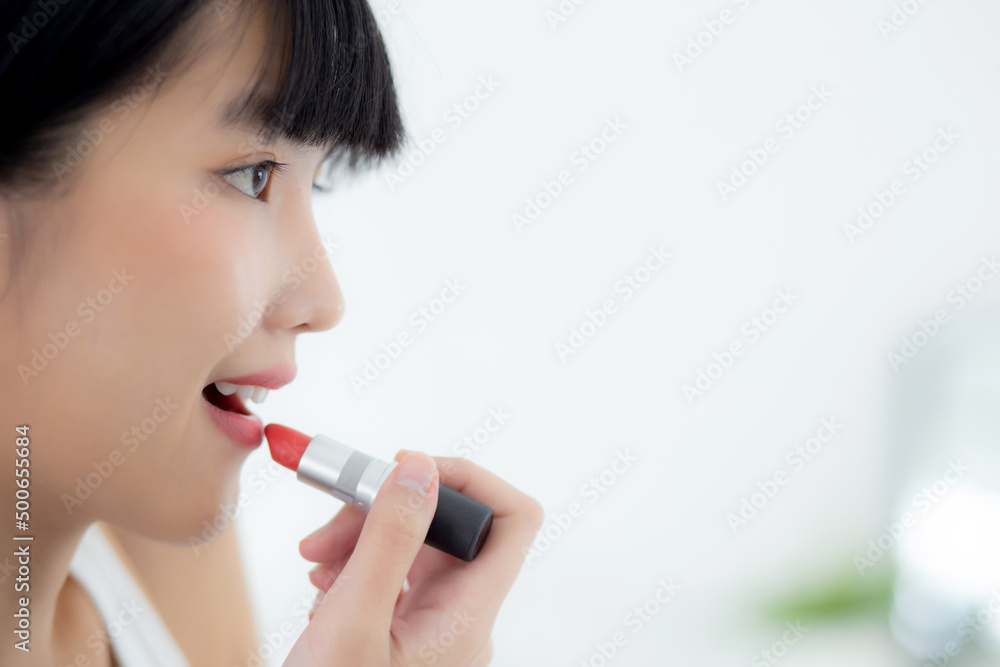Beautiful young asian woman applying lipstick red on mouth, beauty girl looking facial at mirror for makeup cosmetic with lips elegance, make up with sexy of female, skin care and health concept. Beautiful young asian woman applying lipstick red on mouth, beauty girl looking facial at mirror for makeup cosmetic with lips elegance, make up with sexy of female, skin care and health concept.