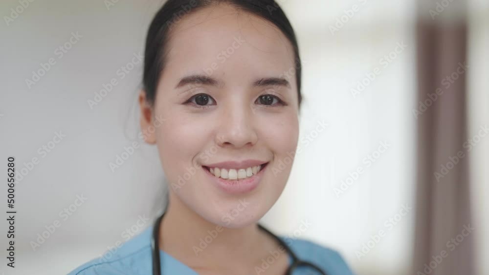 Young beauty female nurse standing and smile with looking at camera in hospital Young beauty female nurse standing and smile with looking at camera in hospital