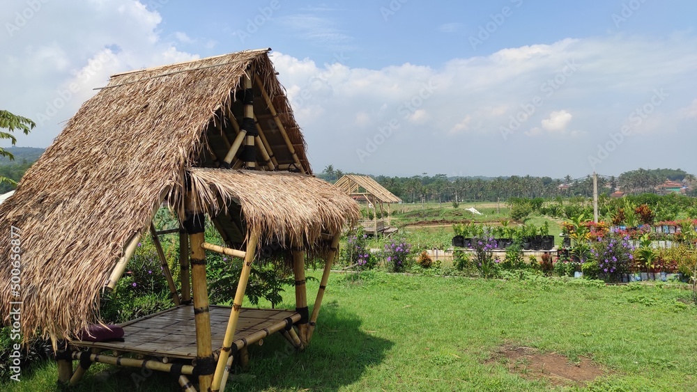 An aesthetic hut in the middle of a grassy yard in the Cikancung area, Indonesia