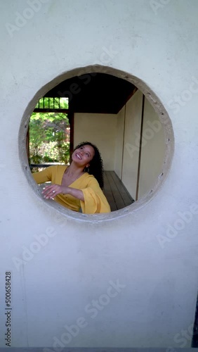 Wallpaper Mural Young Woman Playing in a Round Window Torontodigital.ca