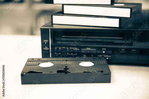 Pile of video cassette tape VHS with video playback old retro style stack concept of vintage electric and electronic appliances multimedia record player device old fashioned.