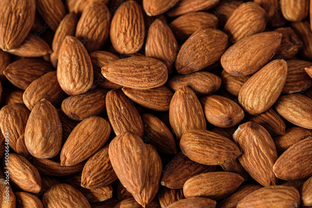 Almonds in wood bowl on wood table.Diet raw material Almonds in wood bowl on wood table.Diet raw material