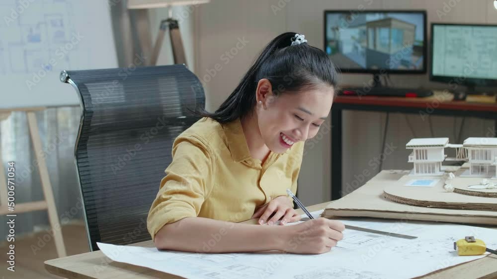 Asian Woman Engineer With A Laptop Drawing Blueprint At The Office
Asian Woman Engineer With A Laptop Drawing Blueprint At The Office