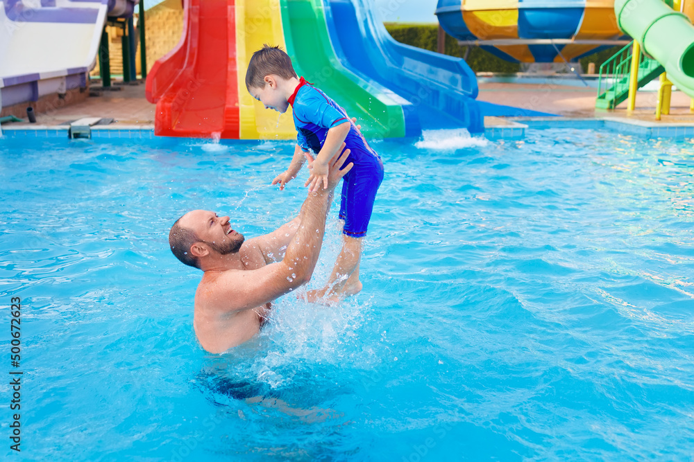 happy father and son together in the aqua park