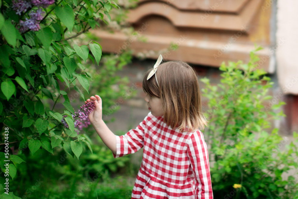 Cute child girl with headband with bow among spring green Cute child girl with headband with bow among spring green