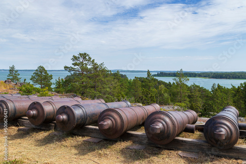 Cannons next to the ruins of the Notvik Tower at the fortress of Bomarsund in Åland Islands, Finland, on a sunny day in the summer.