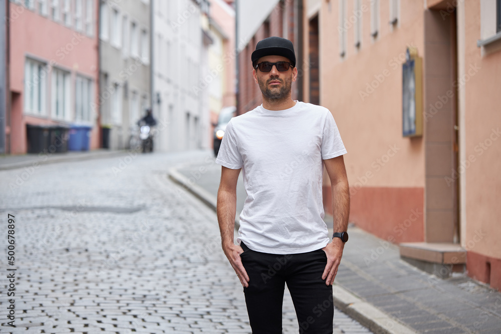 Fototapeta premium White blank t-shirt on a hipster handsome male model with space for your logo or design in casual urban style