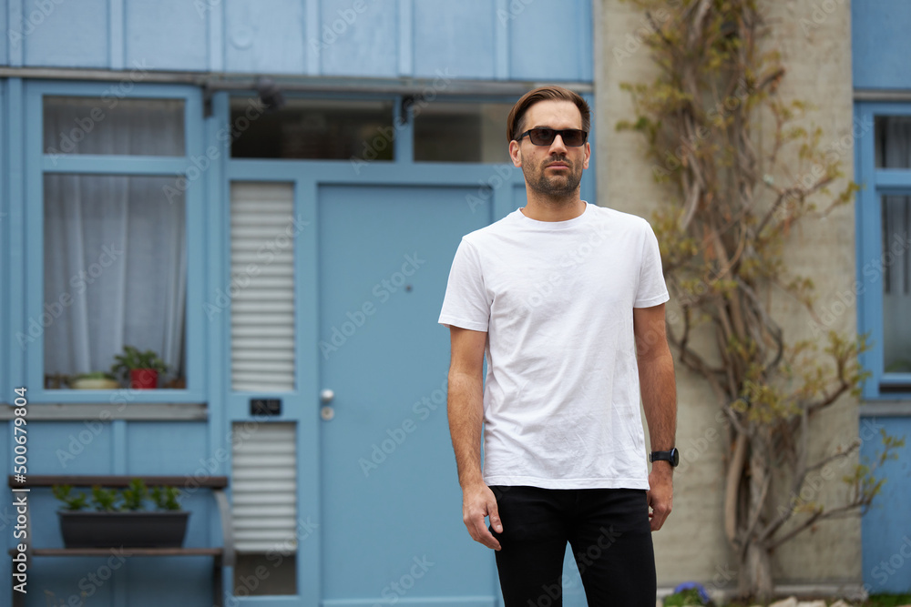 Fototapeta premium White blank t-shirt on a hipster handsome male model with space for your logo or design in casual urban style