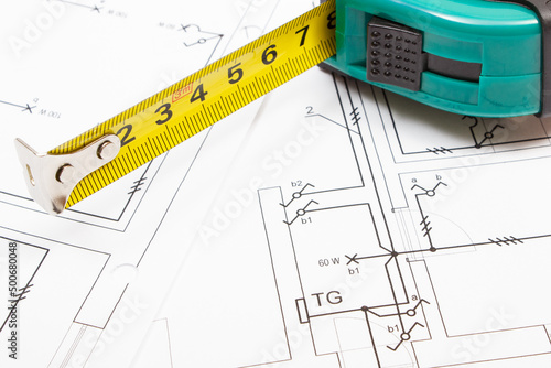 Tape measure with electrical diagrams of house. Building home