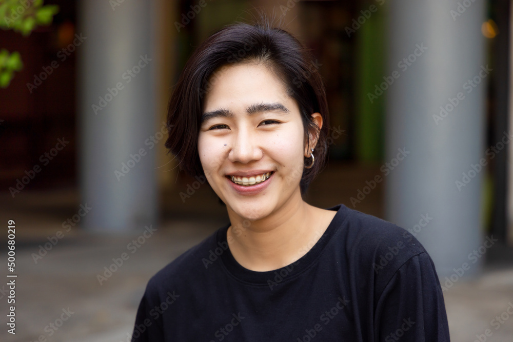 Happy friendly asian non-binary LGBT person smiling to camera - obrazy, fototapety, plakaty 