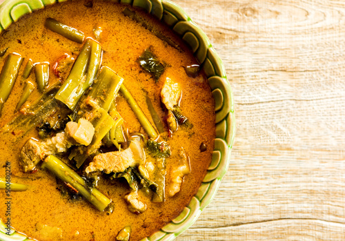 Morning glory with coconut milk  curry or Kang Ta Pho in bowl, Thai famous food.