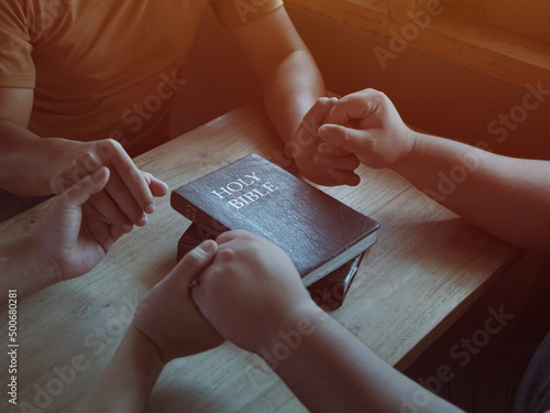 Obraz na plátně Group of different men praying together, Christians and Bible study concept