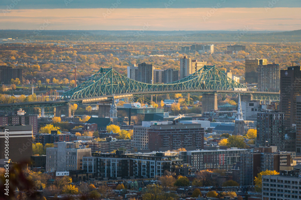 View on Montreal Jacques Cartier bridge from Camilien Houde belvedere on top of Mount Royal, at sunrise on a fall day