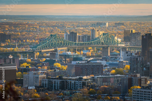 View on Montreal Jacques Cartier bridge from Camilien Houde belvedere on top of Mount Royal, at sunrise on a fall day photo