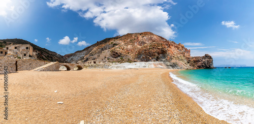 Fototapeta Naklejka Na Ścianę i Meble -  Panoramic view of the remote beach of Thiorichia on the island of Milos, Cyclades, Greece, with the abandoned sulphur Mines on land and emerald sea