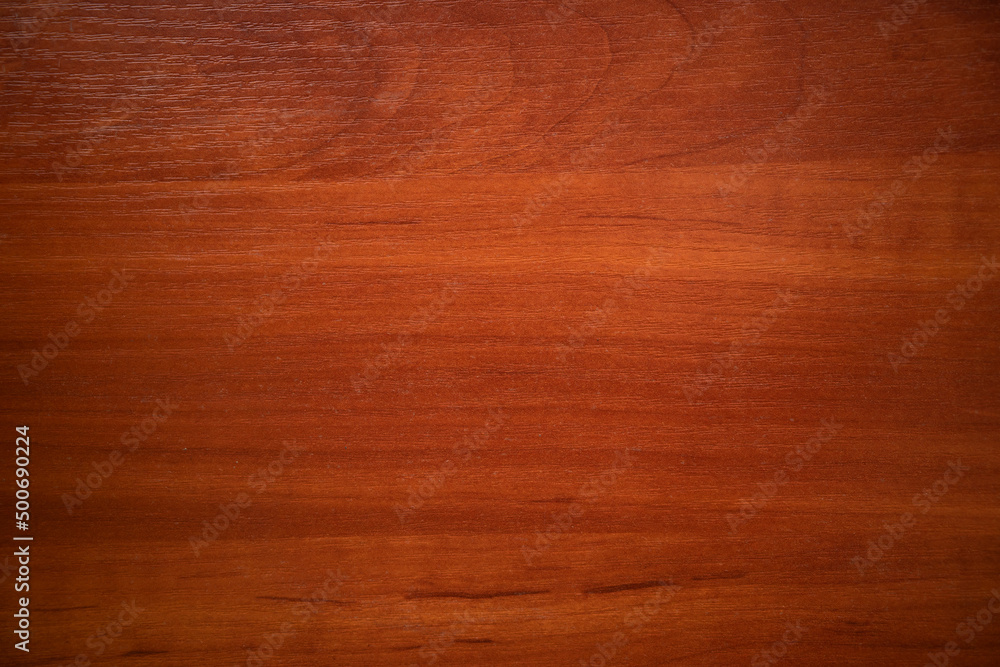 Photo of the texture of natural mahogany. Wood background for text.The wooden wall is red. Photo of the texture of natural mahogany. Wood background for text.The wooden wall is red.