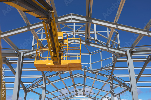 yellow lifting platform for construction in the construction of