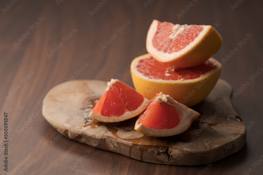 Sliced grapefruit on wood board closeup