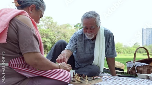 Elderly couple playing chess with bright smile and having fun. Lifestyle concepts about seniority and third age 