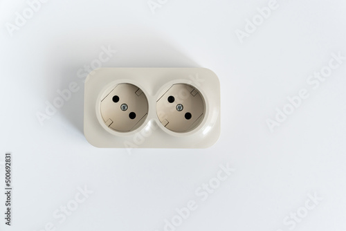 Double socket on a white background. two sockets, united by one monolithic case. The socket has two plug connectors, but is installed in one standard socket. electrical goods store.