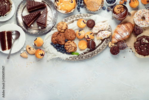 Dessert table with all kinds snacks on light background.