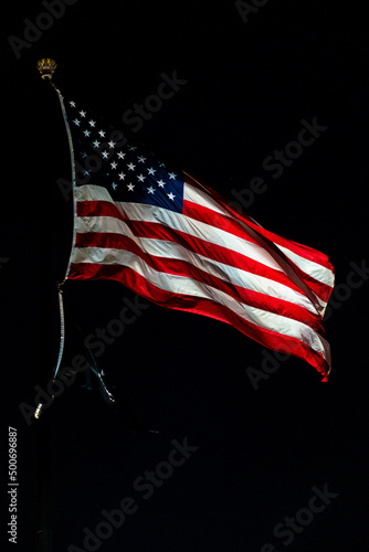 Closeup of american USA flag, stars and stripes, united states of america. On a black background. At night. All seasons. © jirka