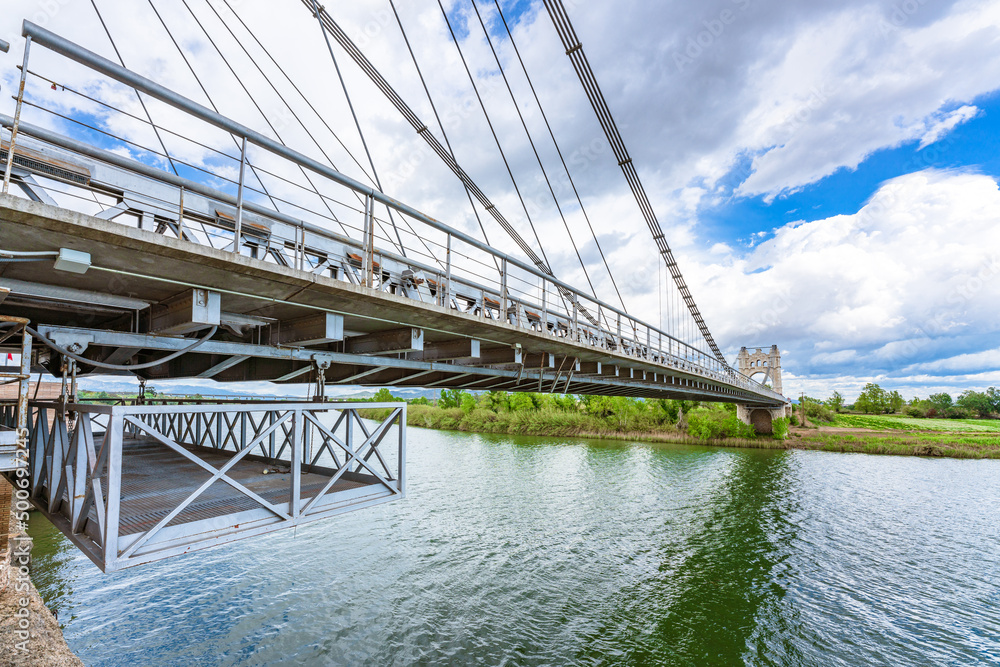 Fototapeta premium El Pont Penjant de Amposta located in the Ebro delta, Tarragona province, Catalonia Spain, is a suspension bridge inaugurated in 1920. It was inspired by the Brooklyn bridge.
