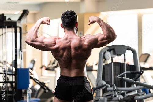 Bodybuilder Performing Back Double Biceps Pose