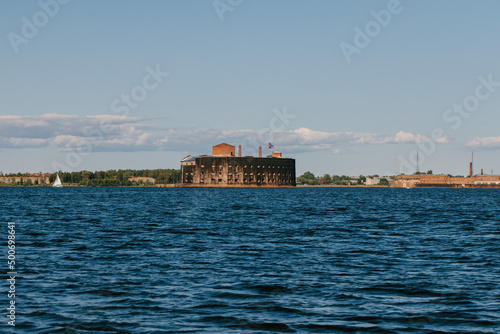 Fototapeta Naklejka Na Ścianę i Meble -  View from a boat on Fort Alexander the First in Kronstadt in the waters of the Gulf of Finland. Island of forts. Summer day
