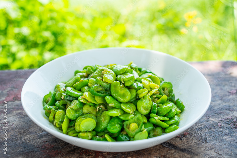 Fried broad beans with local vegetables and green peppers in Hunan, China Fried broad beans with local vegetables and green peppers in Hunan, China