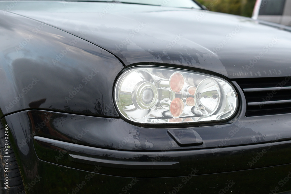Close-up photo of car lights on a rainy day