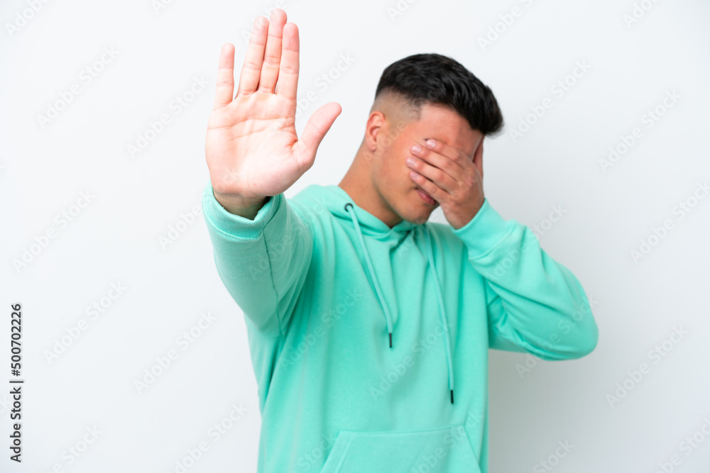 Young caucasian handsome man isolated on white background making stop gesture and covering face Young caucasian handsome man isolated on white background making stop gesture and covering face