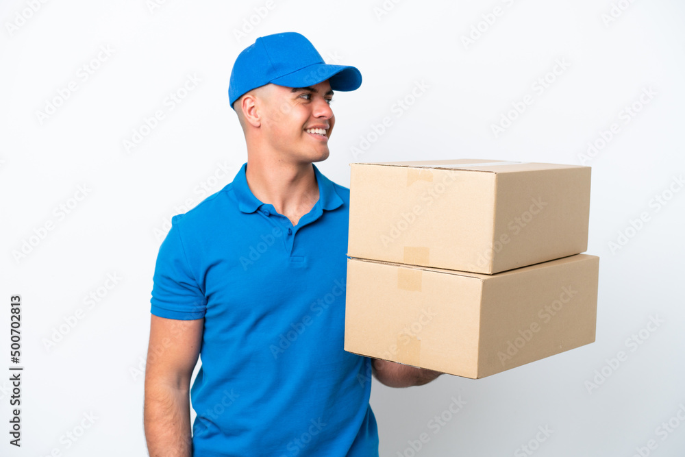 Delivery caucasian man isolated on white background looking side Delivery caucasian man isolated on white background looking side