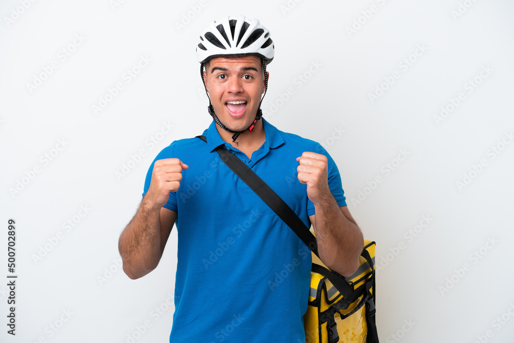 Young caucasian man with thermal backpack isolated on white background celebrating a victory in winner position Young caucasian man with thermal backpack isolated on white background celebrating a victory in winner position