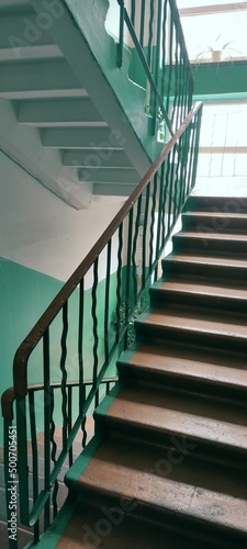 Concrete stairway with handrail of the old five-story building. High quality photo