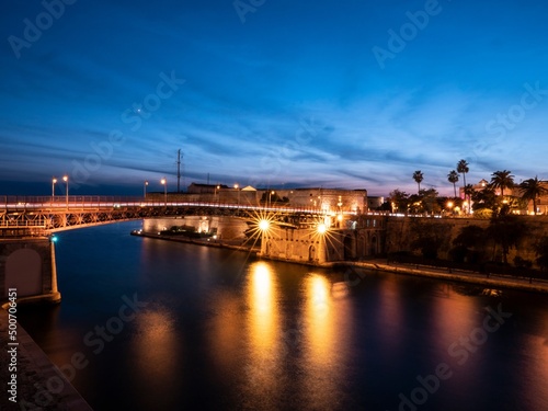 Ponte San Francesco di Paola bridge and Castello Aragonese castle in Taranto, Italy at night